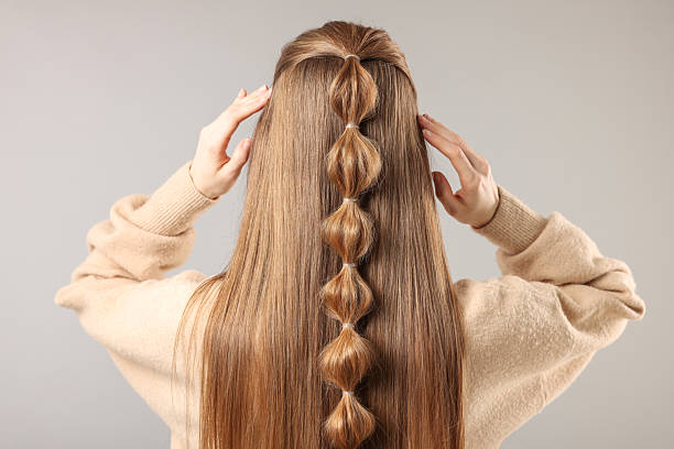 istock Woman with braided hair on grey background, back view 2208206129