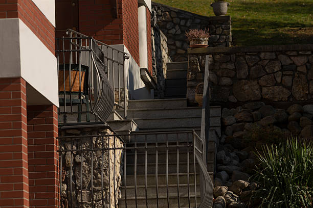 istock Outdoor stairs complement a stone wall and lush green grass background 2208206277