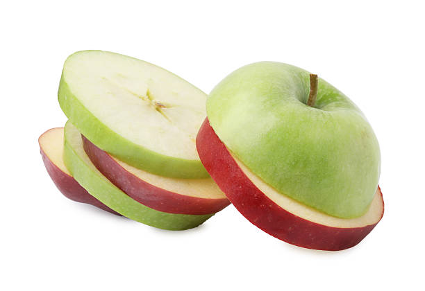 Close-Up Of Sliced Apple Against White Background