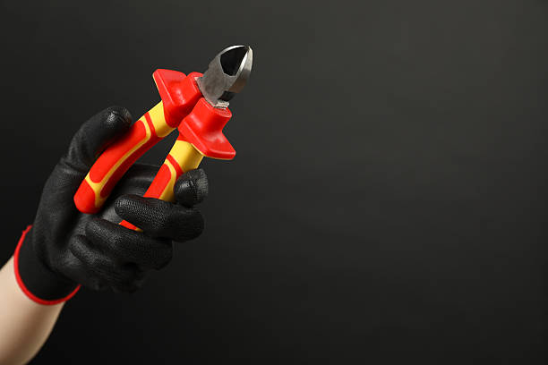 istock Woman with diagonal pliers on dark background, closeup. Space for text 2208218192