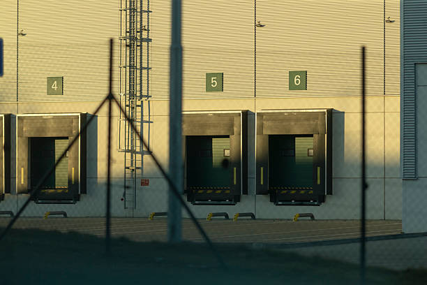 istock Loading Docks of a Warehouse Casting Shadows in the Glow of Sunset 2208219150