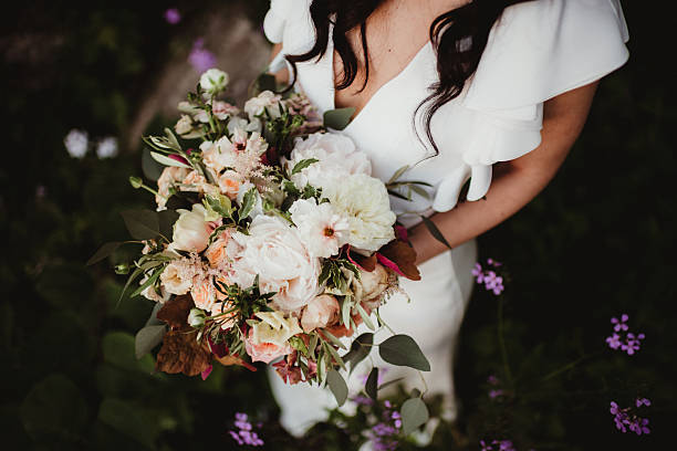 istock Bride holding bouquet of flowers from above 2208219238