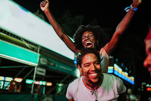 istock Friends celebrating joyfully at night carnival 2208219554