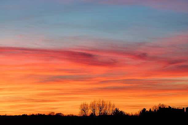 istock Vibrant sunset over silhouetted landscape 2208221872