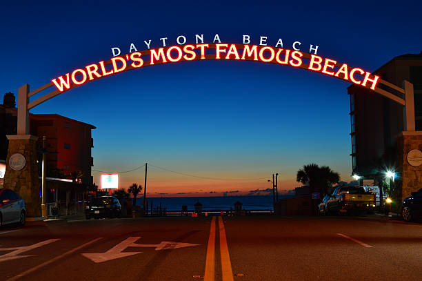 Daytona Beach, FL, USA July 18 An illuminated sign near the ocean welcomes visitors to the Worlds Most Famous Beach, in Daytona Beach Florida at night
