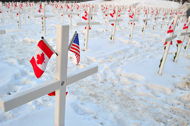 Calgary, AB, Canada November 8 Two flags hang on a memorial to an American killed in action in service in the Canadian military in a park in Calgary Alberta on Remembrance Day