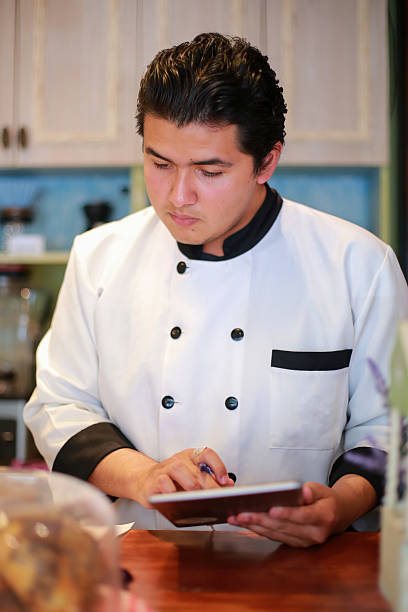 istock Barista uses digital tablet to make the bill 2208232515