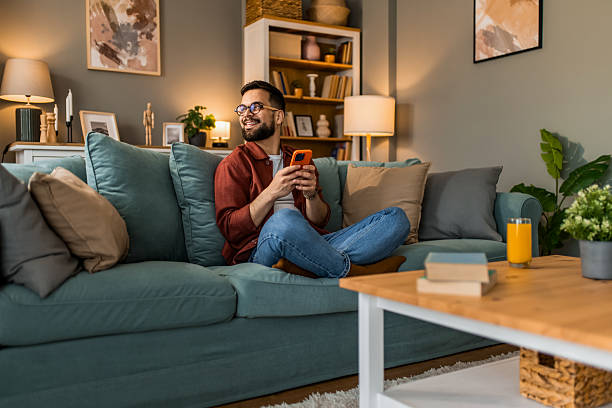istock Happy young man using smart phone at home. 2208233705