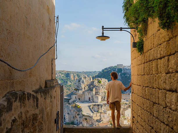 istock Man walking on quaint streets in Matera, Italy 2208237280
