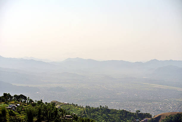 istock A lush green mountain valley under a cloudy sky. 2208238625