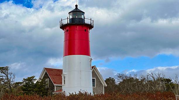 istock Striking red and white lighthouse stands tall against a cloudy sky in Cape Cod, Massachusetts 2208241264