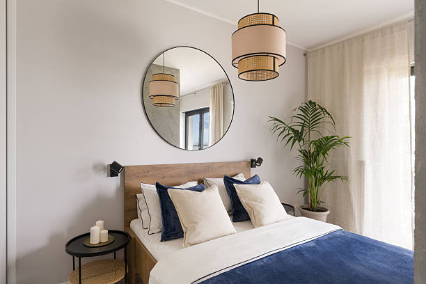 istock Modern Bedroom with Round Mirrors and Potted Plant 2208244016