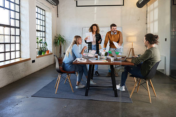 istock Young happy creative team having a meeting at casual office. 2208244648