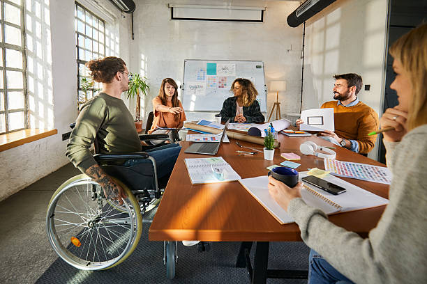 istock Disabled businessman having a meeting with his colleagues. 2208244713