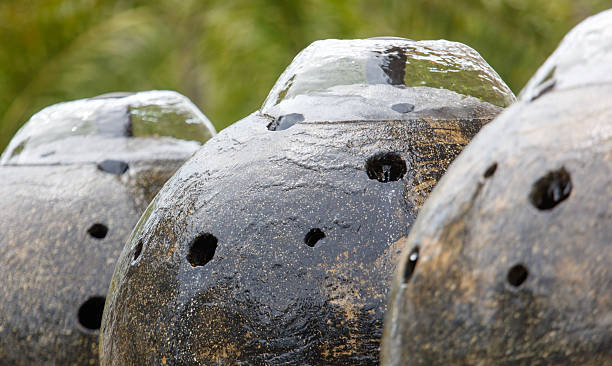 istock Three black and grey vases with holes in them 2208245999
