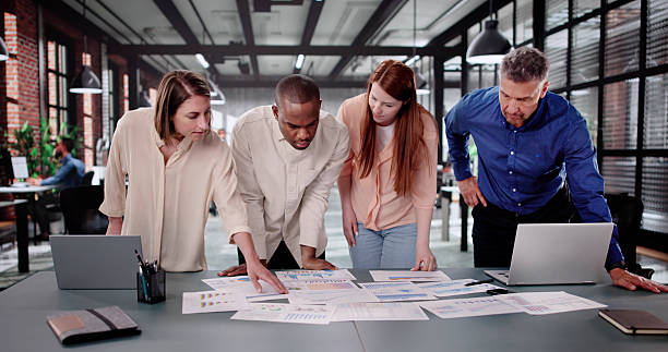 istock Successful Company Team Meeting: Diverse Analyst Group Discussing Financial 2208247665