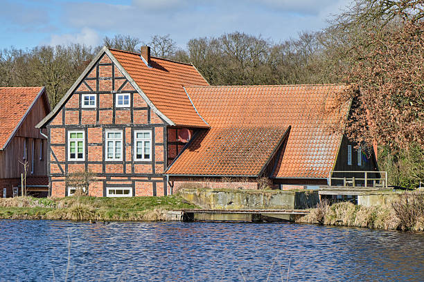 istock Bruchmuehle in Bruchhausen-Vilsen, with half-timbered house and reflection 2208248239