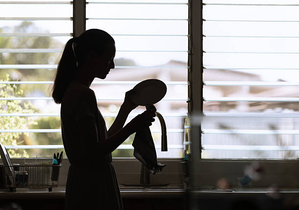 istock Woman cleaning dishes in the kitchen, 2208248662
