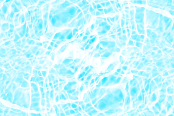 istock Blue water with ripples on the surface. Defocus blurred transparent blue colored clear calm water surface texture with splashes and bubbles. Water waves with shining pattern texture background. 2208249950