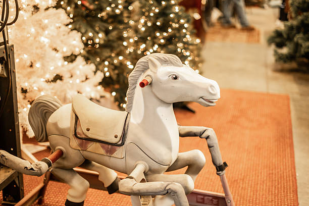 vintage rocking horse, spring horse toy, Christmas decorations, retro toy, holiday season, kids toy, horse ride on, toy horse, Christmas lights, holiday background, white horse toy, classic toy, store interior, festive display, nostalgic toy, indoor lighting, child’s toy, bokeh background, mechanical horse, antique toy, seasonal decor, holiday spirit, Christmas trees, old-fashioned toy, playground toy, childhood memories, festive setup, indoor scene, vintage decor, nostalgic display