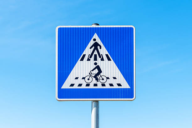 istock Road sign adjacent pedestrian crossing and bicycle crossing, selective focus 2208250894