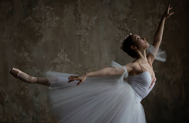 istock Beautiful ballerina in an elegant white dress performs a dance. 2208254204