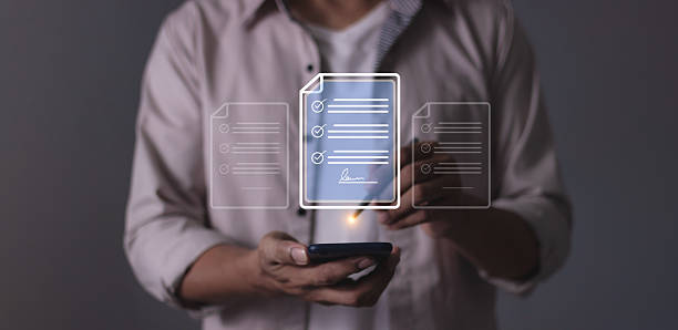 istock Young man hand holding smartphone mobile using a pen touching to sign a Online Business Contract, Electronic signature, Contract signing, Digital documents, Future smart contract 2208256032
