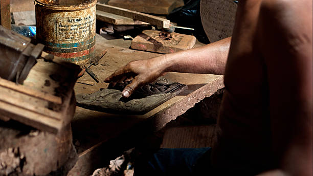istock Dirty hands of worker making clay statue in Balinese style in dark workshop 2208256554