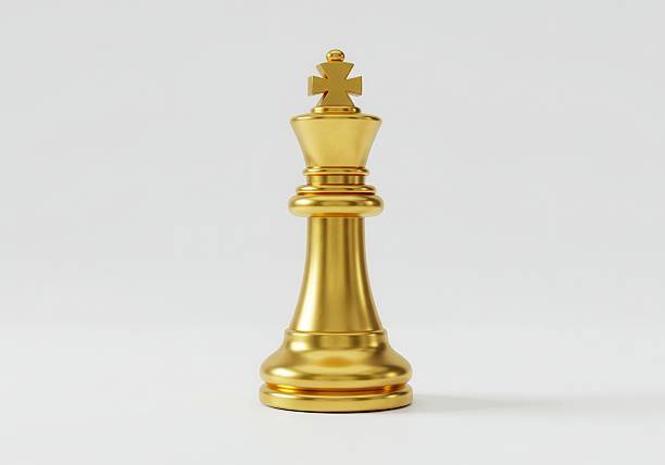 istock Elegant Golden Chess King Piece on a White Surface 2208257970