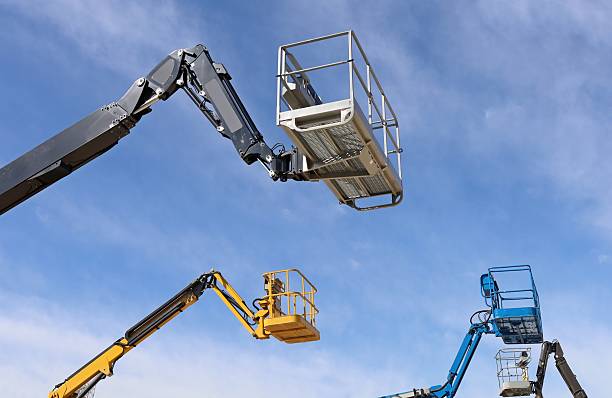 istock Four aerial working platforms of cherry pickers 2208260002