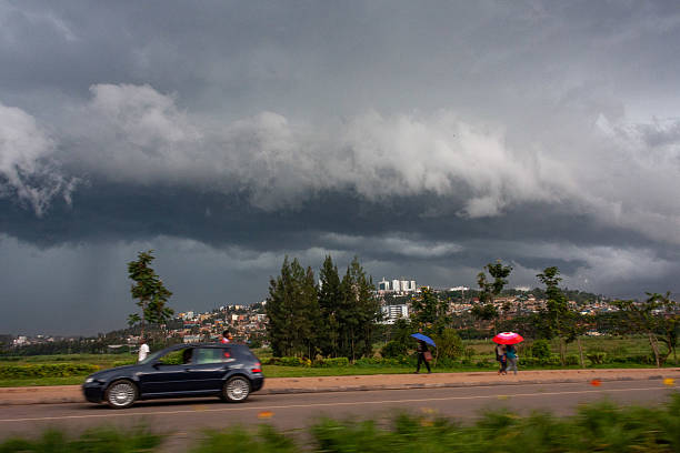 Portrait of businesswoman holding umbrella protecting herself from rain storm