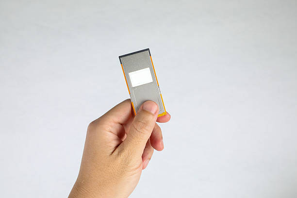 Human hand holding office equipment on white.