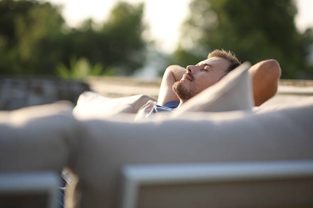 istock Relaxed man sitting in an exterior sofa in a terrace 2208261922