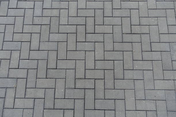 istock Surface of grey concrete pavement with single herringbone layout 2208261958