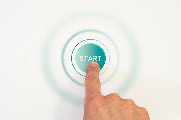 istock Human finger pressing circular start button with glowing rings, symbolizing beginning, activation, or launching of digital process or system 2208262216