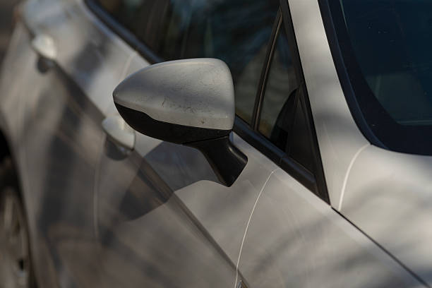 istock Closeup of a side view mirror on a sleek silver car 2208267582