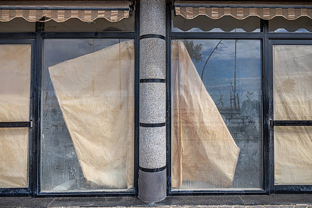 Bankrupt Spanish shop with windows boarded up with kraft paper. The picture is taken in Arrecife which is the main city on the Canary island Lanzarote. Empty shops is an issue in the city