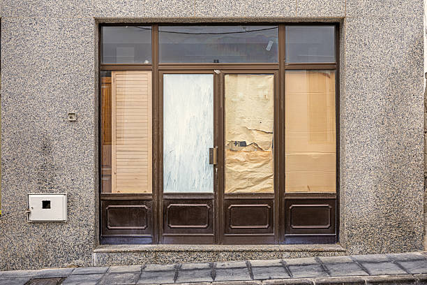 istock Doors to a closed shop covered with brown paper 2208268777