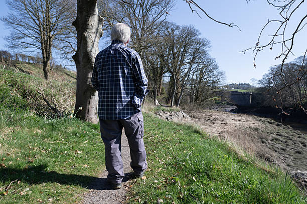 istock Retired man walking on a rural footpath 2208268980