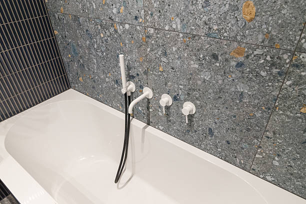 istock Bathtub with faucet and shower head 2208270344