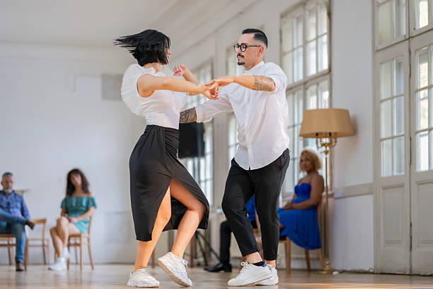 istock Energetic Caucasian Couple Dancing in a Bright Studio Setting 2208272788