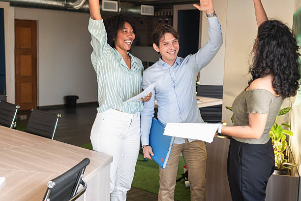 istock Enthusiastic business team celebrating success in modern office 2208274099