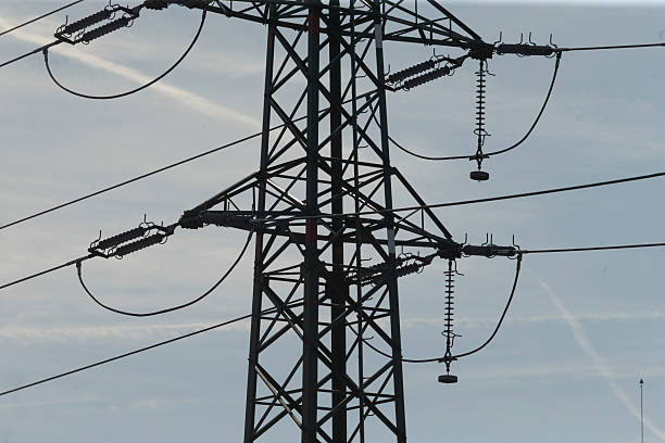 istock A silhouette of a power line structure against a blue sky 2208276932
