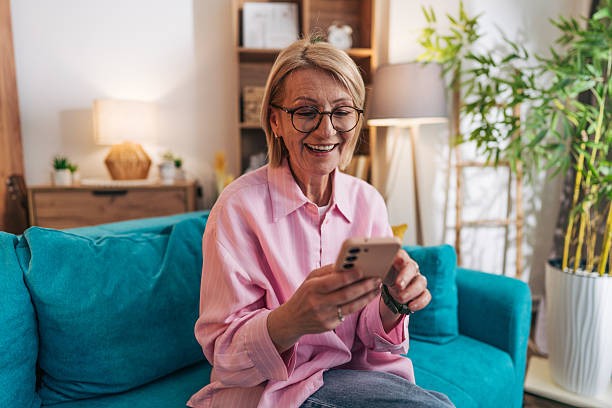 istock Happy senior woman using smartphone at home, enjoying retirement 2208277136