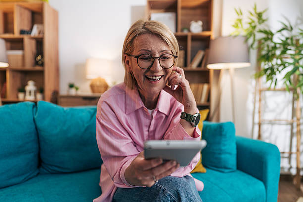 istock Happy senior woman using digital tablet at home 2208277367