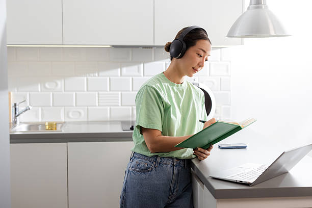 istock Korean woman taking notes and using a laptop at home 2208282497