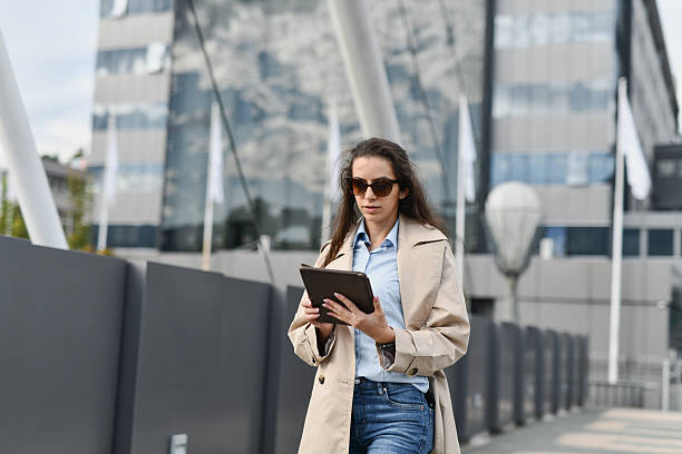 istock Female Going Over Client Brief on Tablet Before Entering Client Meeting Room 2208283124