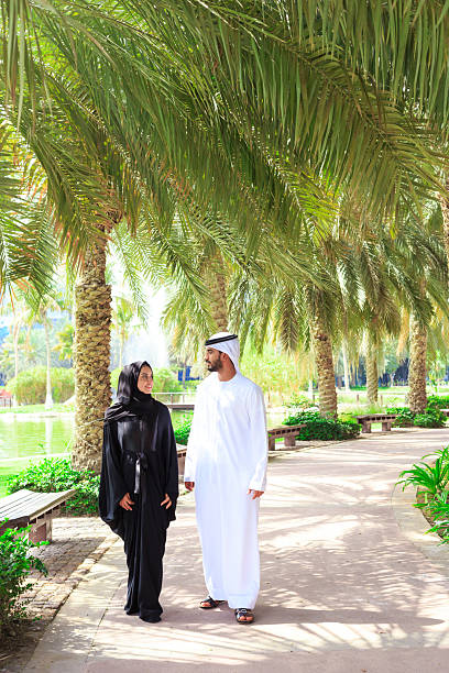 istock Middle Eastern couple walking in the park 2208286196