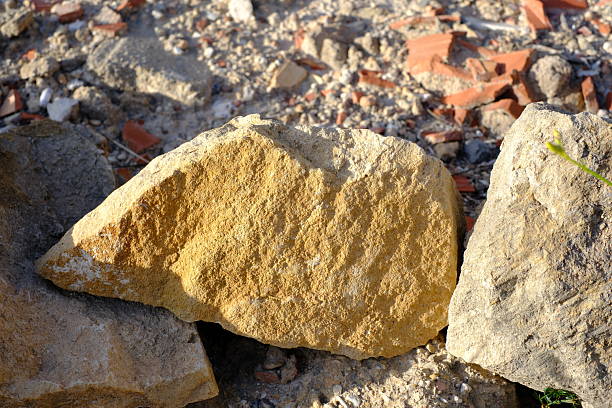 Sunlit natural rock formation amidst rocky terrain.