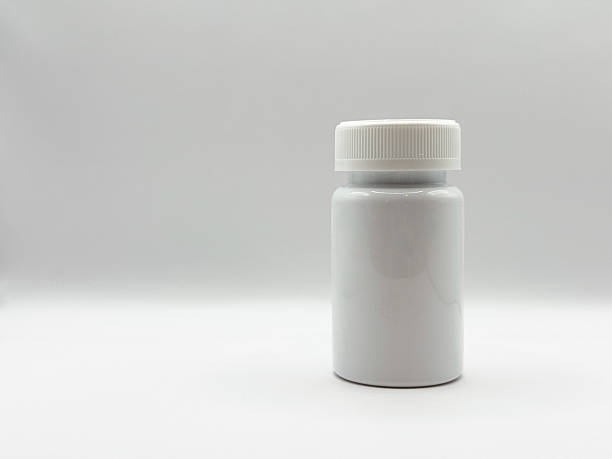 istock White medicine jar with closed lid stands on white background on left in front view image 2208288270